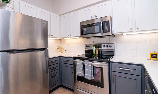 Small Ad View of kitchen with modern cabinetry and white brick backsplash