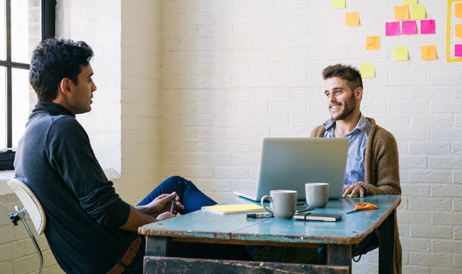 Small Ad Guys sitting together in a meeting